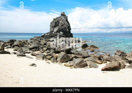 rock formation on apo island beach in the philippines Stock Photo