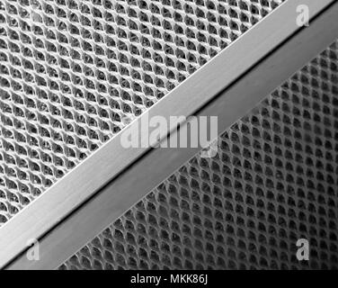 Reflection of ventilation sieve on shiny black granite surface. Stock Photo