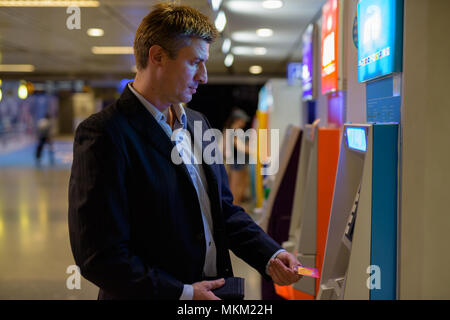 Businessman inside the subway train station in Bangkok, Thailand Stock Photo