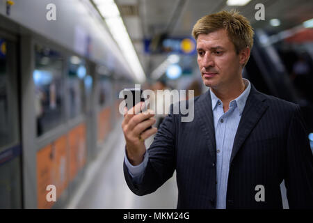 Businessman inside the subway train station in Bangkok, Thailand Stock Photo