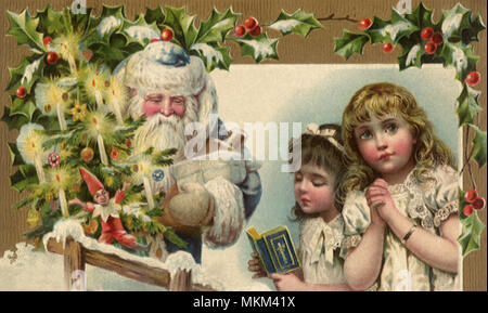 Santa and Praying Girls Stock Photo