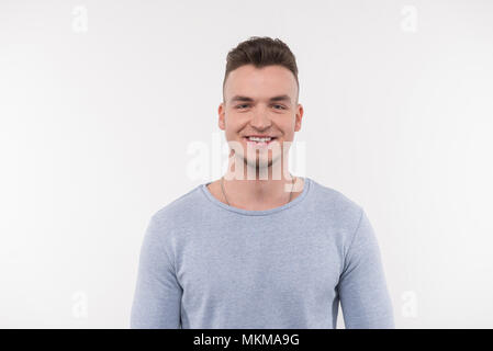 Joyful young man being in a good mood Stock Photo