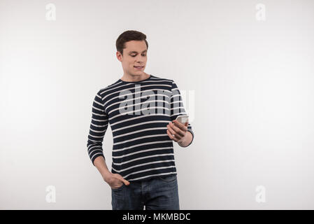 Happy nice man looking at the smartphone screen Stock Photo