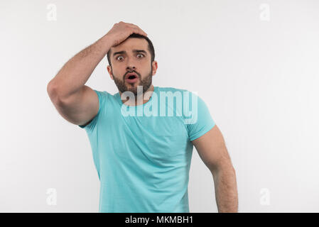 Nice surprised man touching his head Stock Photo