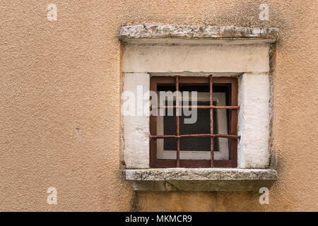 Small window with wrought iron grille in Croatia (Island Cres) Stock Photo