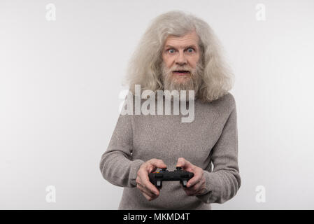 Excited elderly man enjoying the game Stock Photo