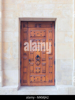 Old wooden door in brick wall Stock Photo