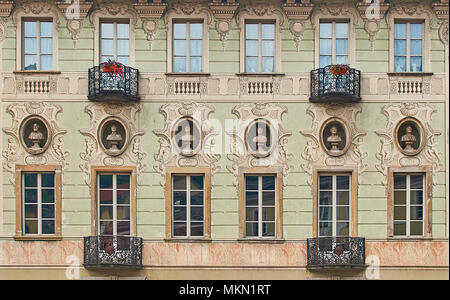 Vintage sculpture portraits of Galileo Galilei, Torquato Tasso, Dante Alighieri, Francesco Petrarca, Ludovico Ariosto and Alessandro Volta on a facade of an old building in Bellinzona, Switzerland Stock Photo