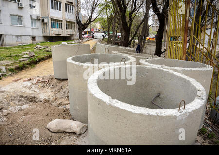 Stack of Sewer concrete pipes in a construction site Stock Photo