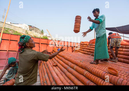 Pottery load unload on transporting boat at Burigonga River near Sadarghat, Dhaka, Bangladesh. Stock Photo