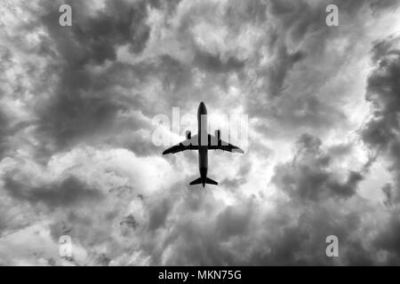 under a big jet plane taking off, black and white Stock Photo