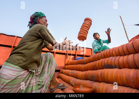 Pottery load unload on transporting boat at Burigonga River near Sadarghat, Dhaka, Bangladesh. Stock Photo