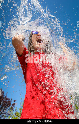 Waterfight splash in the garden in the UK summer Stock Photo