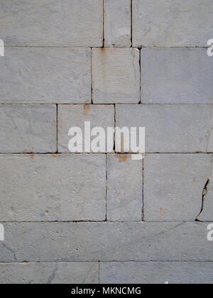 Old grey block stone wall. No mortar. Stock Photo