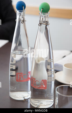 Water bottles with hinged stoppers at the Financial Conduct Authority (FCA) offices, North Colonnade, Docklands, London. Logo corporate branding is cl Stock Photo