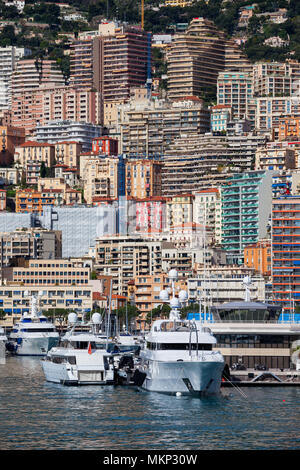 Monaco principality from the port, apartment buildings, block of flats, houses on a steep coastal mountain slope Stock Photo