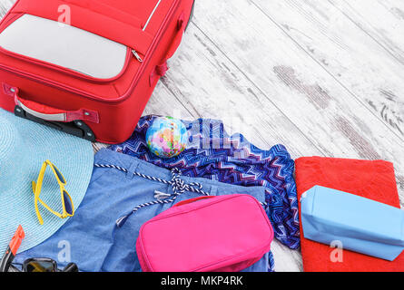 Open suitcase with different men clothes and accessories on sofa Stock  Photo - Alamy