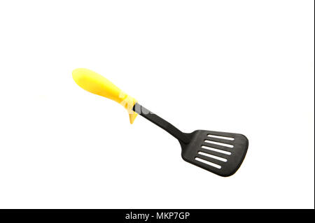 Plastic spade of frying pan with yellow grip isolated on white background Stock Photo