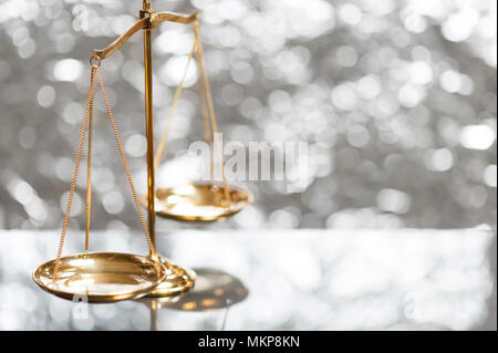 Close up of gold brass balance scale, Sign of justice on bokeh background Stock Photo