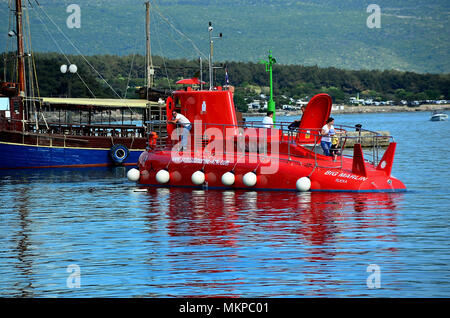 Croatia, Krk. The red semisubmarines are boats with glass bottom, Unique combination of panorama of the old town of Krk from the deck of the semisubmarine as well as the underwater excursion. Stock Photo