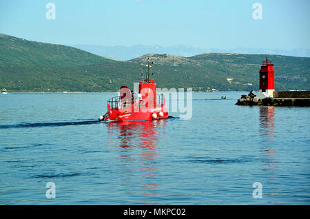 Croatia, Krk. The red semisubmarines are boats with glass bottom, Unique combination of panorama of the old town of Krk from the deck of the semisubmarine as well as the underwater excursion. Stock Photo