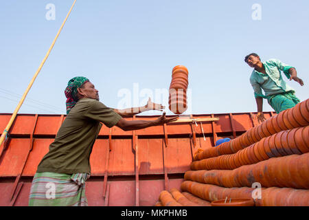 Pottery load unload on transporting boat at Burigonga River near Sadarghat, Dhaka, Bangladesh. Stock Photo