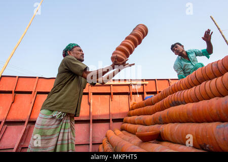 Pottery load unload on transporting boat at Burigonga River near Sadarghat, Dhaka, Bangladesh. Stock Photo