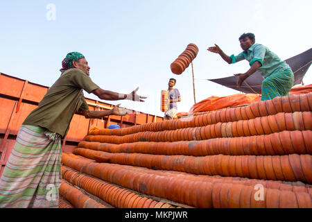 Pottery load unload on transporting boat at Burigonga River near Sadarghat, Dhaka, Bangladesh. Stock Photo