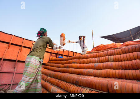 Pottery load unload on transporting boat at Burigonga River near Sadarghat, Dhaka, Bangladesh. Stock Photo