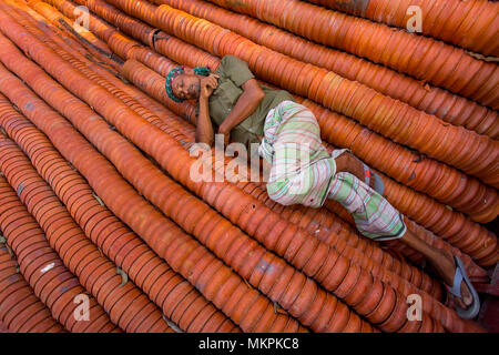 Pottery load unload on transporting boat at Burigonga River near Sadarghat, Dhaka, Bangladesh. Stock Photo