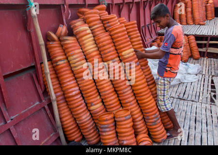 Pottery load unload on transporting boat at Burigonga River near Sadarghat, Dhaka, Bangladesh. Stock Photo