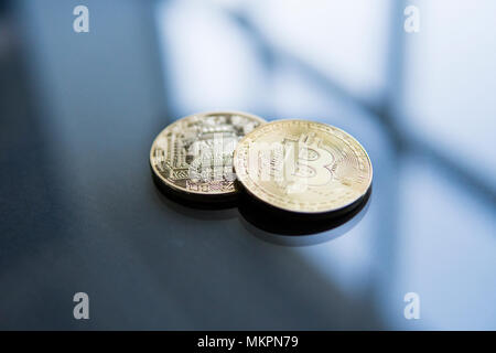 Golden Bitcoins on a reflective surface on a background. Profit from mining crypto currencies. Bussiness, commercial. Currency