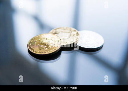 Golden Bitcoins on a reflective surface on a background. Profit from mining crypto currencies. Bussiness, commercial. Currency