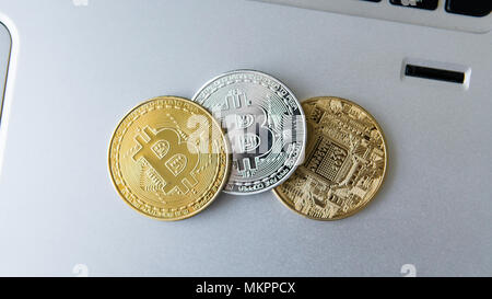 Golden and silver bitcoin coins on a laptop. Digital crypto currency. Virtual money. Metal coins of bitcoin. Bussiness, commercial, Exchange. Stock Photo