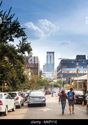 Johannesburg, South Africa, April 29-2018: People walking down the street in fashionable inner city district. Stock Photo