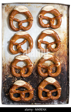 pretzels on baking sheet isolated on white background Stock Photo