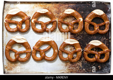 pretzels on baking sheet isolated on white background Stock Photo