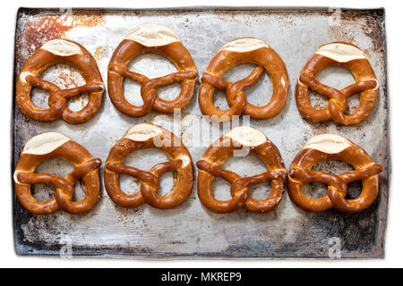 pretzels on baking sheet isolated on white background Stock Photo