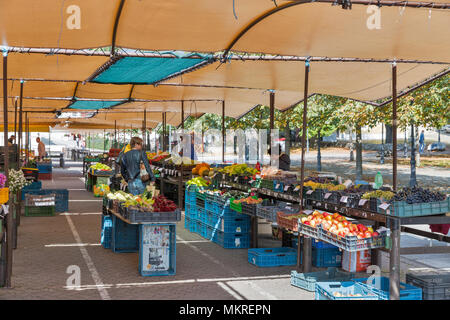 BANSKA BYSTRICA, SLOVAKIA - SEPTEMBER 29, 2017: People visit fruits and vegetables market stall in city center. It is a city in central Slovakia locat Stock Photo