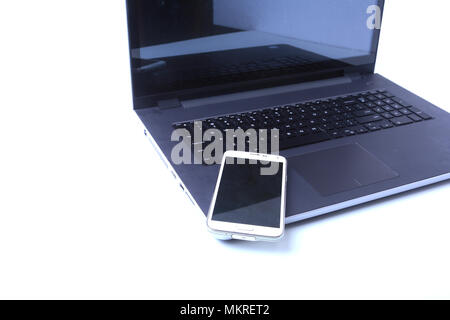 Office workplace with laptop, smart phone on table. Stock Photo