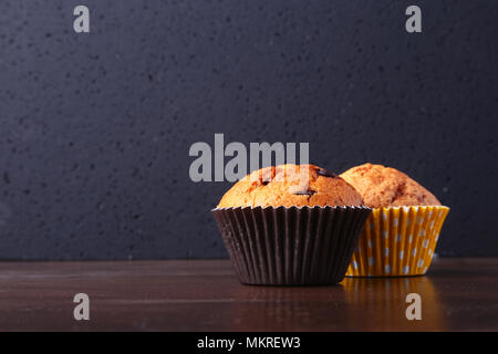 Tasty chocolate cupcakes, muffins on a white wooden table. Stock Photo