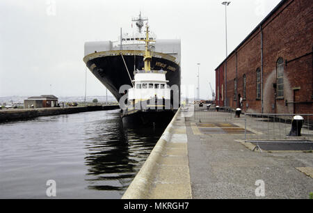 Bulk car carrying ship Venus Diamond leaving Newport Docks spring 1992. Wales UK. Escorted by a tug boat. Welsh coastal port, British Coast Docks Stock Photo