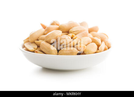 Salty roasted peanuts in bowl isolated on white background. Stock Photo