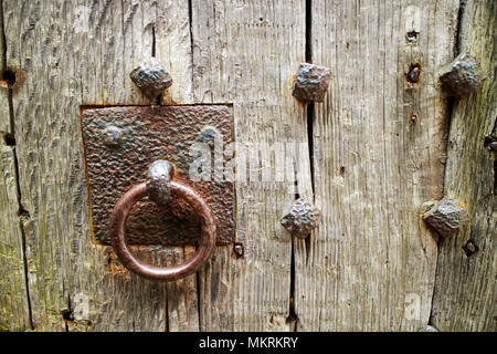 handle iron studded old oak door to the lock up Lacock village wiltshire england uk