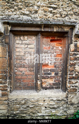 windows bricked up to avoid the window tax where the phrase daylight robbery comes from Lacock village wiltshire england uk Stock Photo