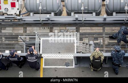 180507-N-SO730-0035 NORFOLK, Va. (May 7, 2018) Sailors assigned to the aircraft carrier USS George H.W. Bush (CVN 77), and Marine Nationale (French navy) sailors observe procedures in preparation for an underway, May 7, 2018. The ship is underway in the Atlantic Ocean conducting carrier air wing exercises with the French navy to strengthen partnerships and deepen interoperability between the two nations' naval forces. (U.S. Navy photo by Mass Communication Specialist 3rd Class Joe Boggio). () Stock Photo