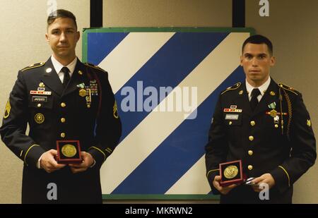 Staff Sgt. Joshua Jacques and Spc, May 7, 2018. Jamie Martinez-Feliciano, fire support specialists with 1st Battalion, 9th Field Artillery Regiment, 3rd Infantry Division Artillery pose for a photo after being announced the 3rd ID Noncommissioned Officer and Soldier of the Year at Fort Stewart, Ga. May 7, 2018. Jacques and Martinez-Feliciano will represent the Marne Division during the XIII Airborne Corps competition in June. (U.S. Army photo by Staff Sgt. Sierra A. Melendez, 50th Public Affairs Detachment, 3rd Infantry Division Public Affairs). () Stock Photo