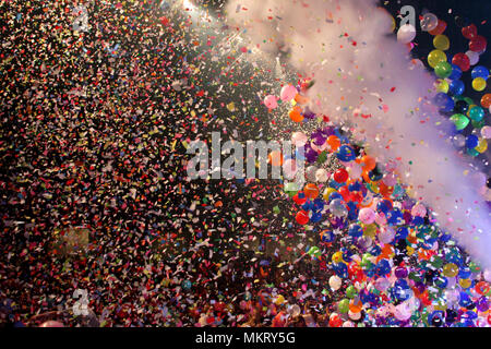 Thousands of balloons and confetti flying at the end of show Stock Photo