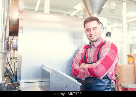 Photo of businessman with arms crossed by roaster Stock Photo