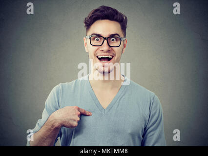 Young happy man amazed with prize pointing at himself in disbelief. Stock Photo